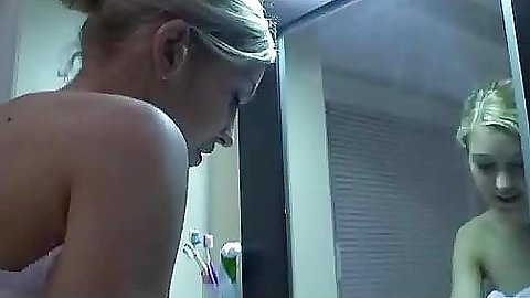 Cute teen babe playing around with a tooth brush