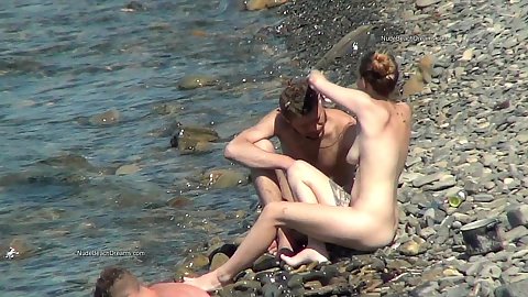 Naked amateur teen nudist and her bf relaxing naked on a beach with voyeur camera catching their bodies