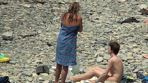 Girl gets naked and takes off her clothes on pubic amateur beach spy camera footage on hot summer day