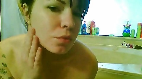 Sexy brunette teel oiling up in the bathroom
