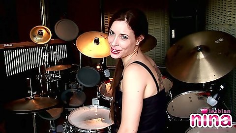 Brunette Nina showing her ass in panties solo by the drums set