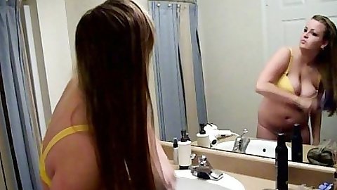 Solo Britney Bangs doing her hair in front of the mirror