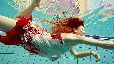 Marketa the redhead in a sexy dress giving and swimming naked solo
