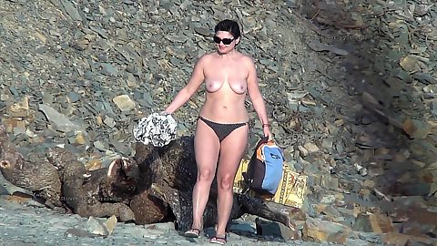 Small boobed topless outdoor public brunette in voyeur nudist beach area for public to see