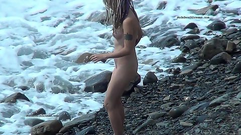 Nudist amateur on a public beach dreadlocks wearing little teenie girl goes into the water to wet her ass