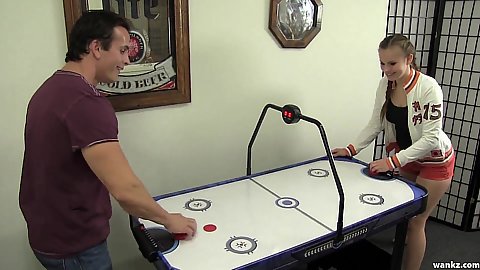 Playing some air hockey with brunette coed in red shorts s1