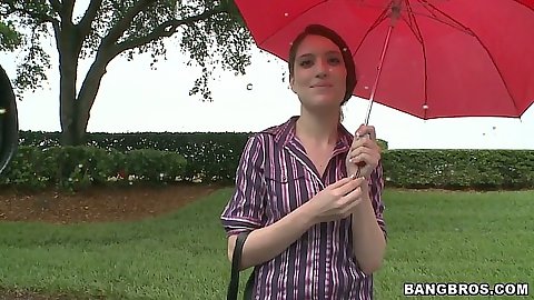 Zarena Summers standing under the rain picked up for bangbus ride