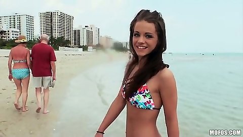 Teen Michelle Bella goes to the public beach outdoors in a sex tight bikini