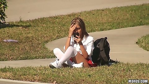 Young and innocent school girl teen Jessicka Alman doing her homework on the lawn