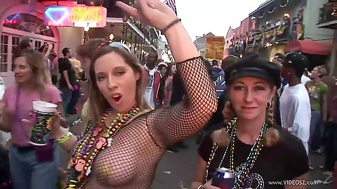 Dancing fishnet girl sin public during mardi gra outdoors on the street